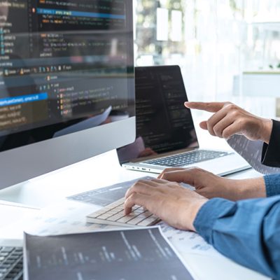 Person developing website or web application on iMac